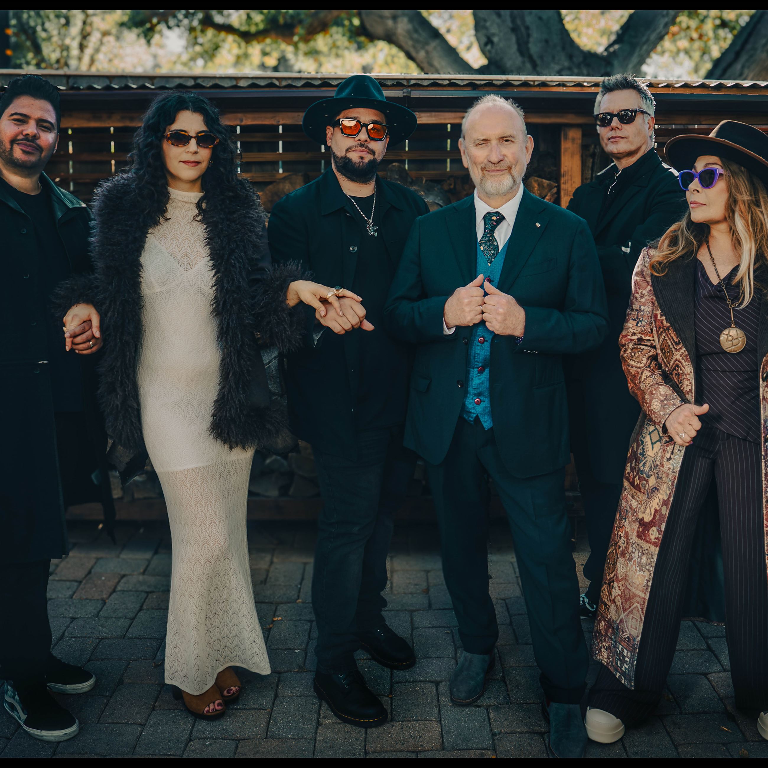 Members of Blue Oyster Cult band stand together outdoors